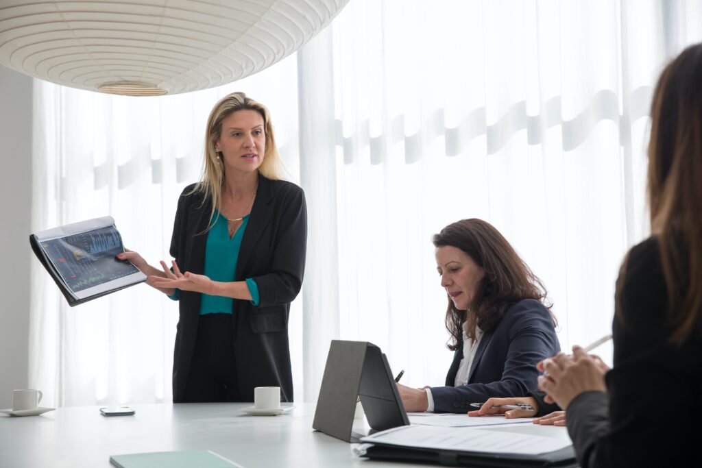 menopausal-aged women in the workplace delivering a presentation.